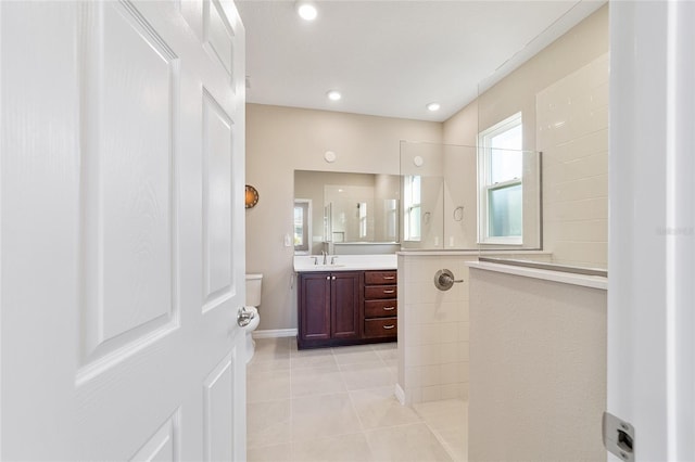 bathroom with tile patterned floors, a shower, and vanity