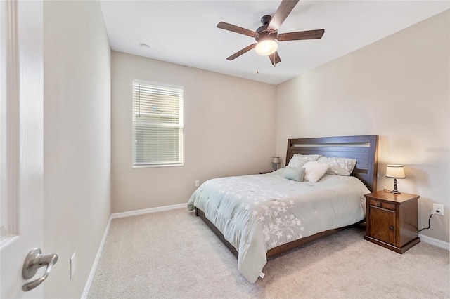 bedroom with ceiling fan and light colored carpet