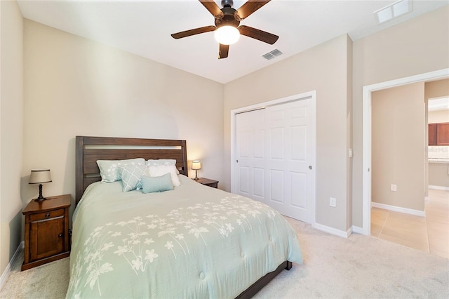 bedroom featuring ceiling fan, a closet, and light carpet