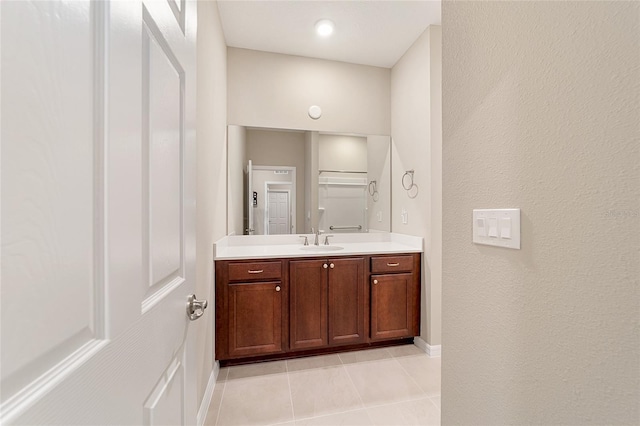 bathroom with tile patterned floors and vanity