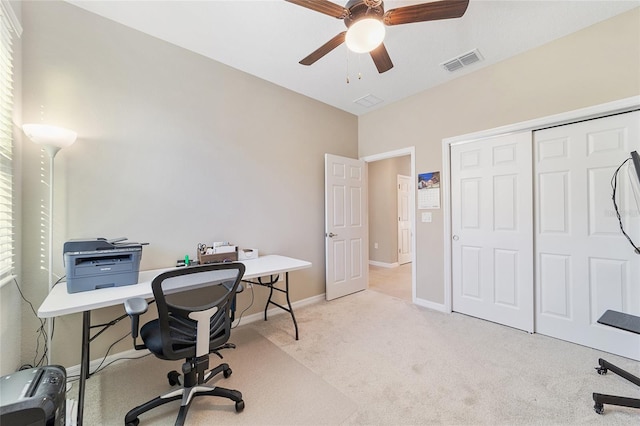 carpeted office featuring ceiling fan