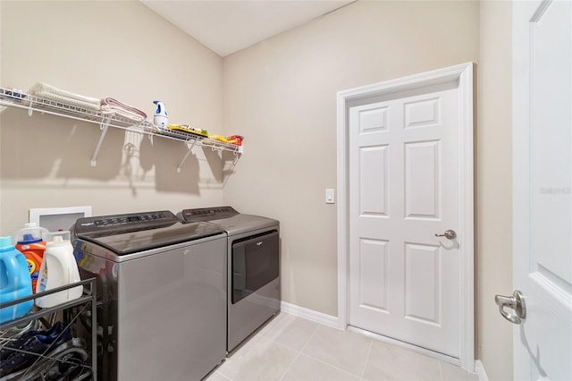 laundry area featuring light tile patterned floors and separate washer and dryer