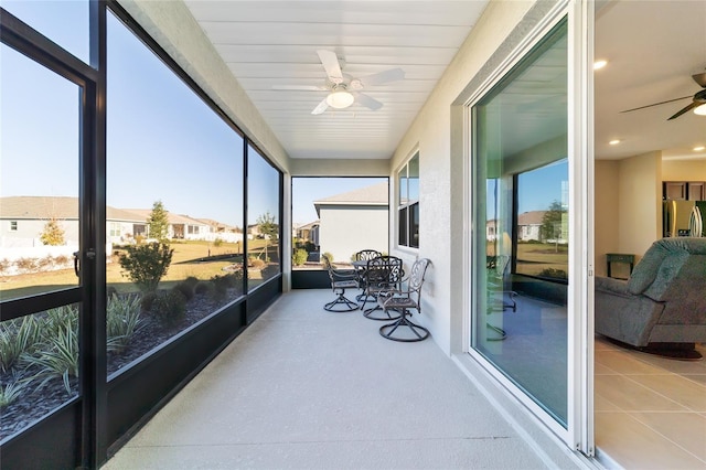 sunroom with a wealth of natural light and ceiling fan