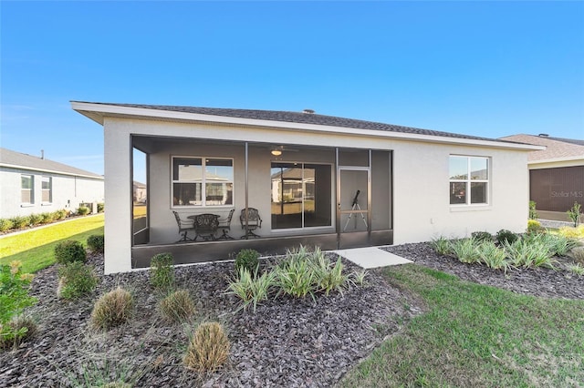 back of property with a sunroom