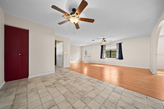 unfurnished living room featuring ceiling fan and light hardwood / wood-style flooring