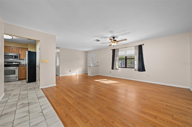 unfurnished living room with light hardwood / wood-style flooring and ceiling fan