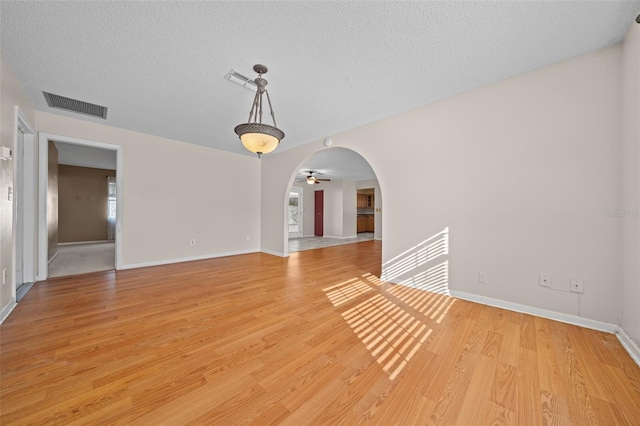 interior space featuring ceiling fan, a textured ceiling, and light wood-type flooring