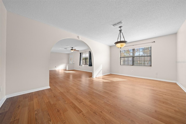 interior space featuring a textured ceiling, light hardwood / wood-style floors, and ceiling fan