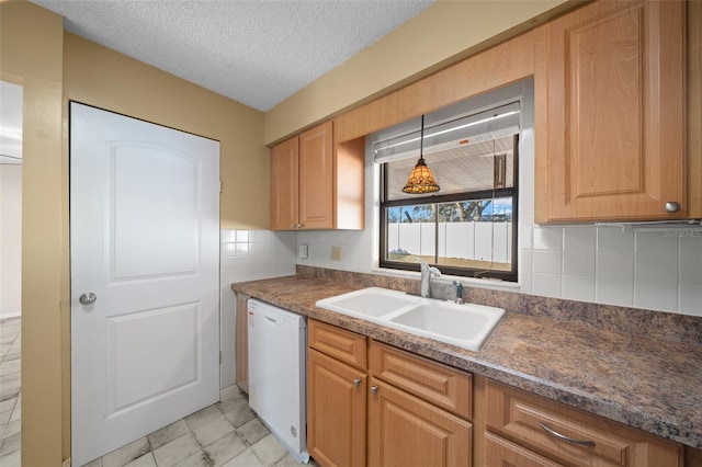 kitchen featuring sink, white dishwasher, pendant lighting, a textured ceiling, and decorative backsplash