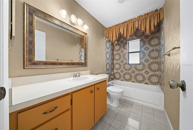 full bathroom with vanity, tile patterned floors, tiled shower / bath combo, toilet, and a textured ceiling