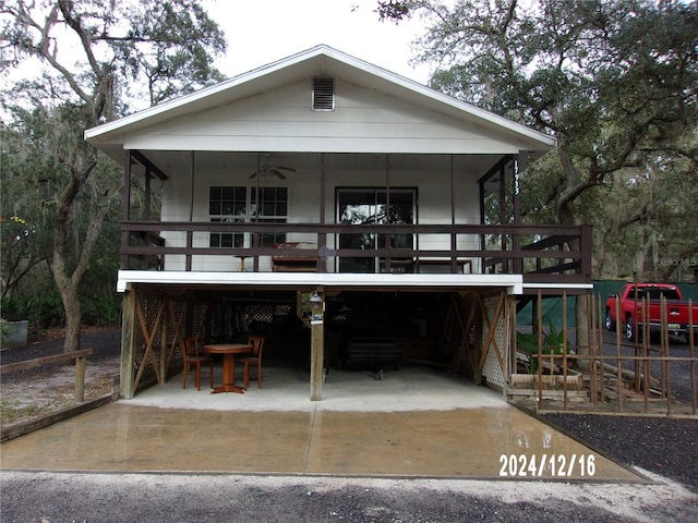 rear view of house featuring a carport and ceiling fan