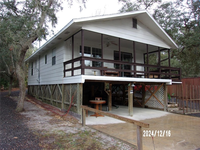 back of property with ceiling fan