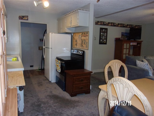 kitchen with white fridge, dark carpet, black / electric stove, and sink