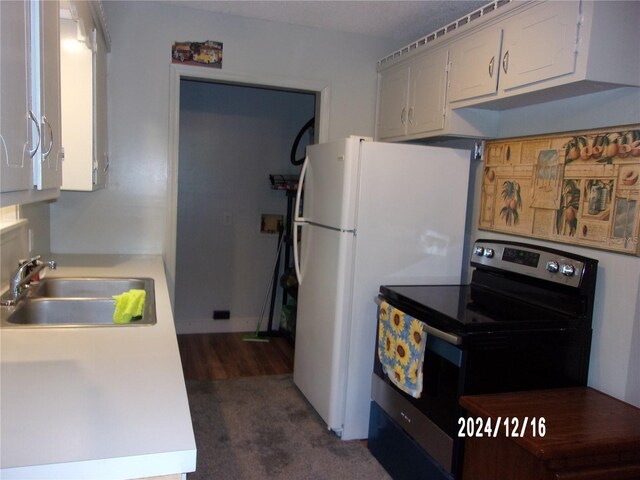 kitchen featuring white cabinets, white refrigerator, black / electric stove, and sink