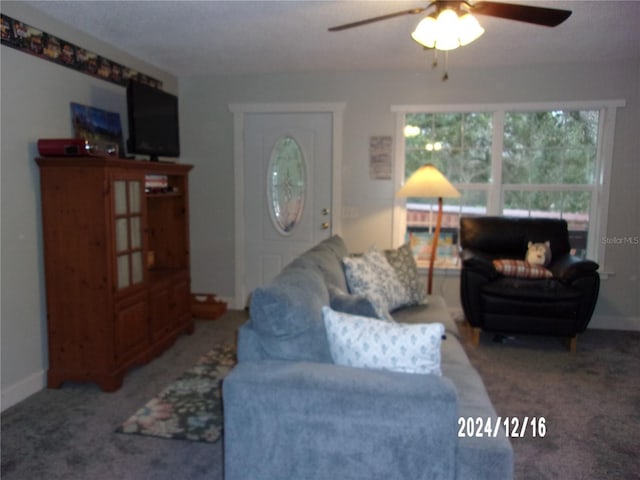 living room featuring carpet flooring and ceiling fan