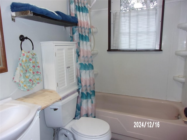 full bathroom with vanity, shower / tub combo, and toilet