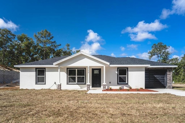 ranch-style home with a front yard and a garage