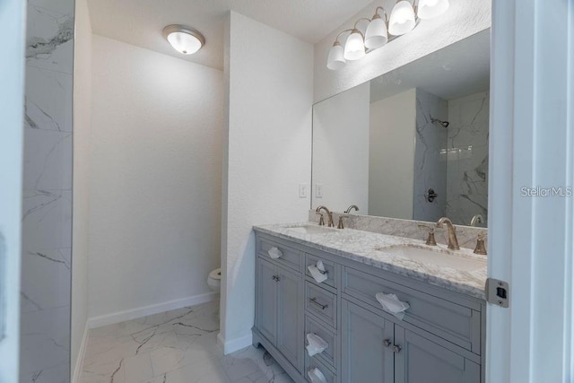 bathroom with walk in shower, vanity, and toilet