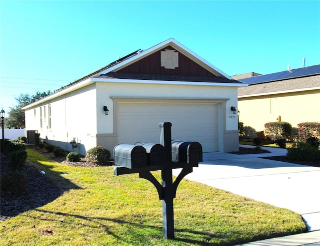 view of home's exterior with central air condition unit, a yard, and a garage