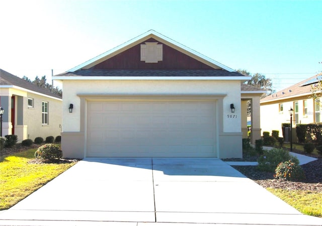 9871 SW 99th Loop, Ocala, FL 34481 - ranch-style home with roof with shingles, stucco siding, concrete driveway, and an attached garage