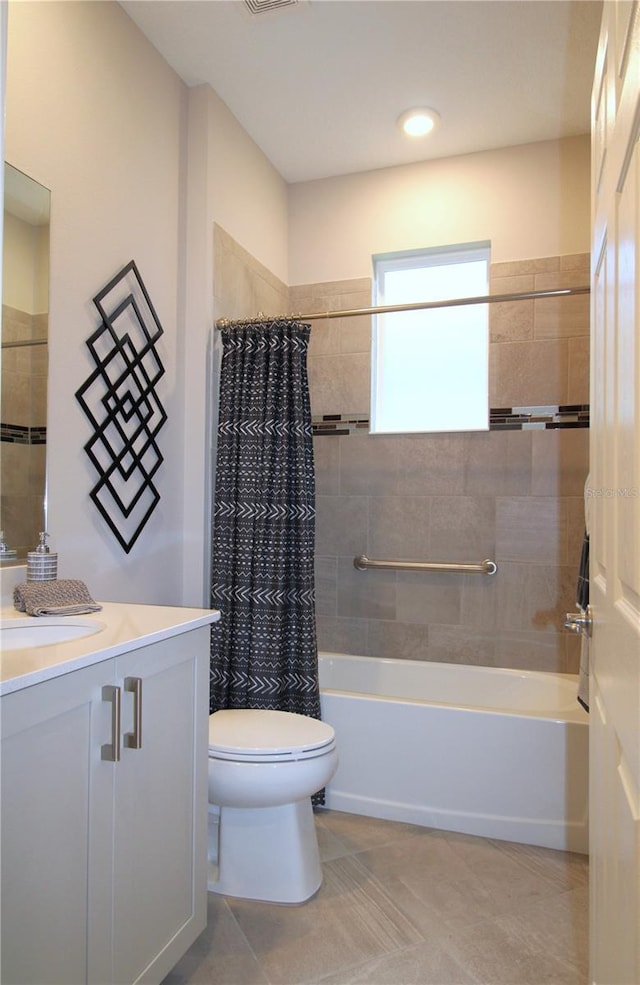 full bathroom featuring tile patterned flooring, vanity, toilet, and shower / bathtub combination with curtain