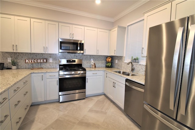 kitchen featuring sink, light stone countertops, tasteful backsplash, white cabinetry, and stainless steel appliances