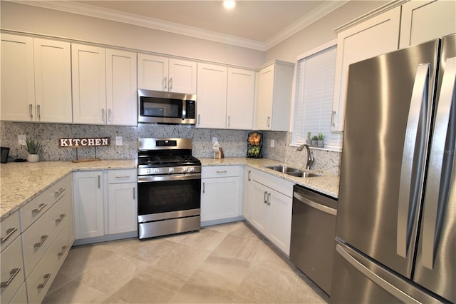 9871 SW 99th Loop, Ocala, FL 34481 - kitchen with stainless steel appliances, crown molding, tasteful backsplash, light stone counters, and white cabinets