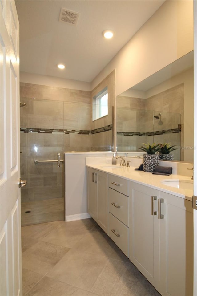 bathroom featuring vanity and a shower with door