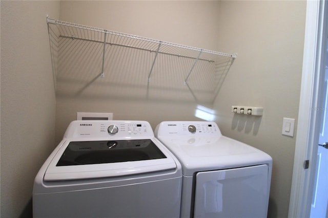 laundry area featuring washing machine and clothes dryer