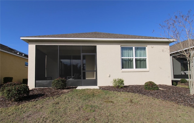 9871 SW 99th Loop, Ocala, FL 34481 - rear view of house featuring a sunroom, a lawn, and stucco siding