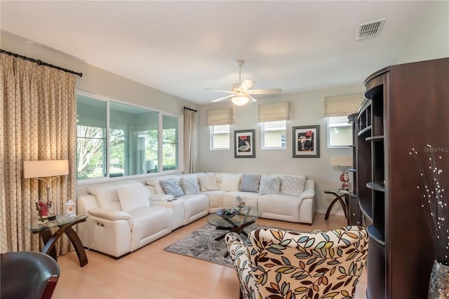 living room featuring ceiling fan and light hardwood / wood-style floors