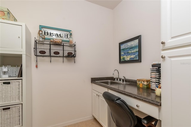 laundry area with cabinets and sink