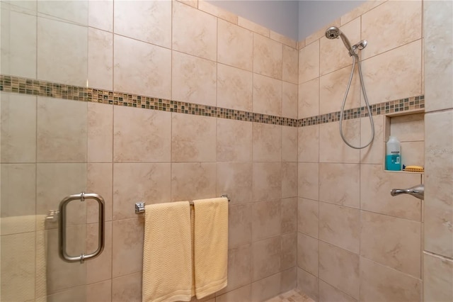 bathroom with a shower with door