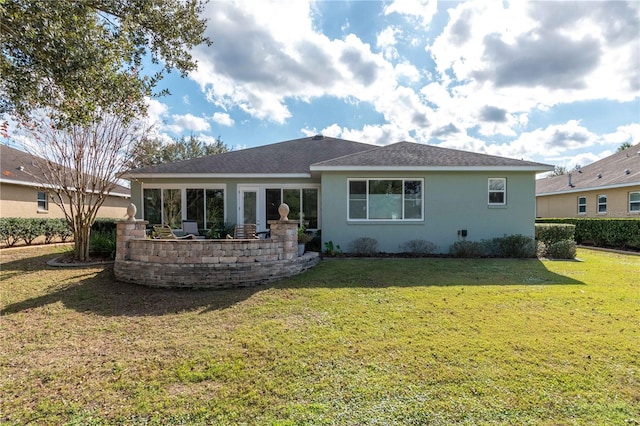 back of property featuring a lawn