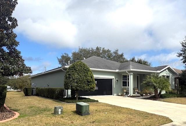 ranch-style house with a garage and a front yard