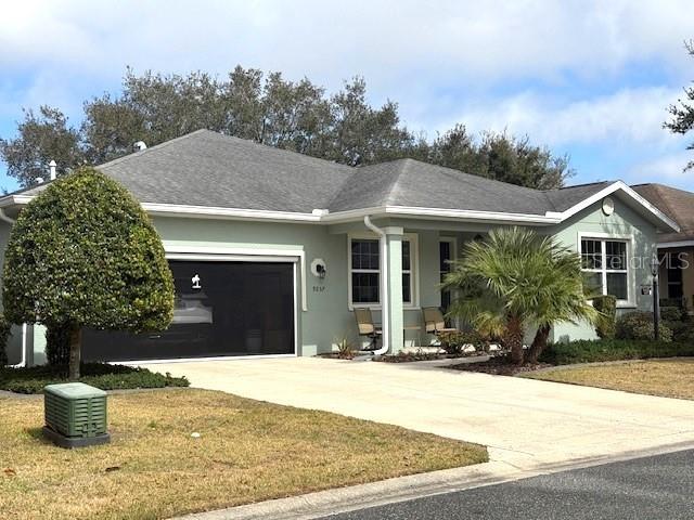 single story home featuring a garage and a front lawn