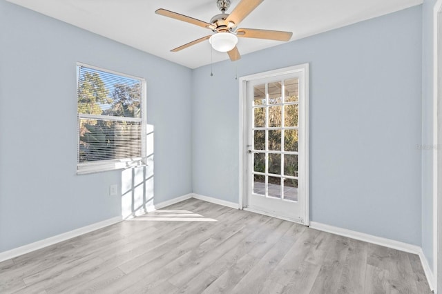 spare room featuring light hardwood / wood-style floors and ceiling fan