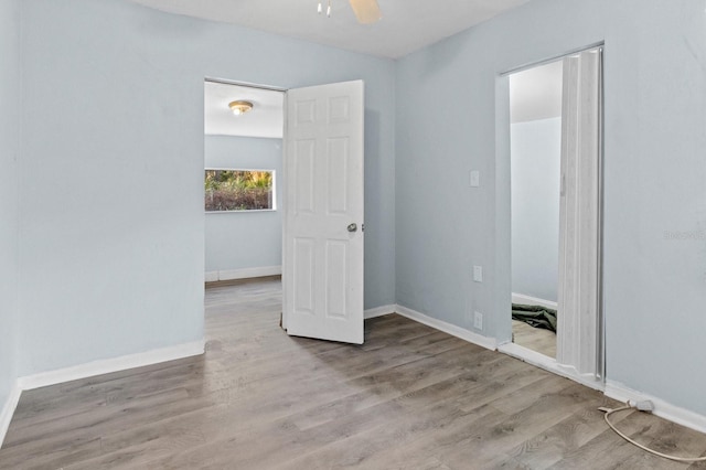 unfurnished bedroom with light wood-type flooring and ceiling fan