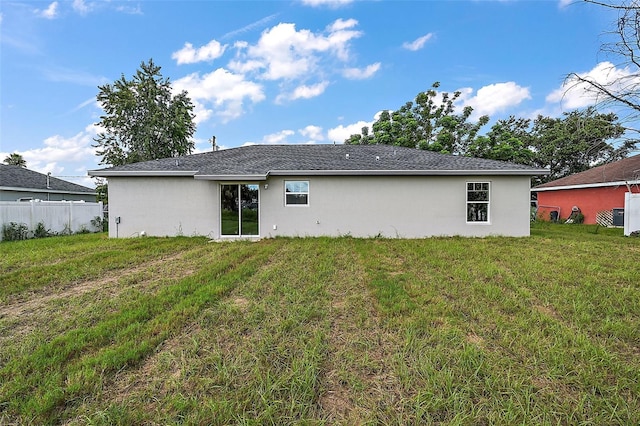 back of property featuring a lawn