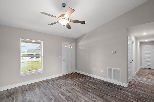 unfurnished room with ceiling fan and dark wood-type flooring