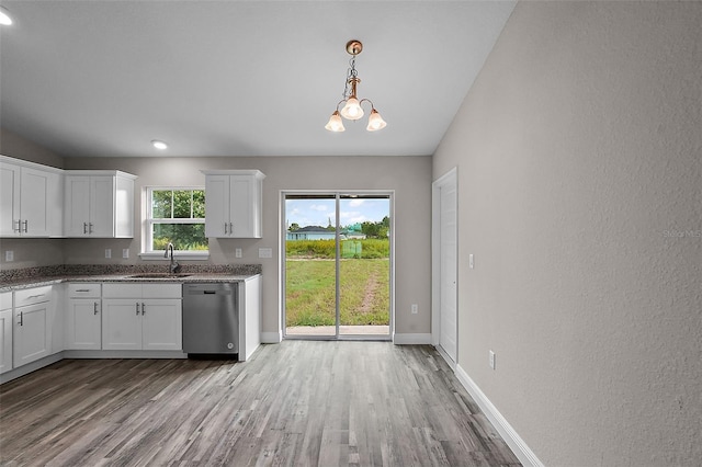 kitchen featuring white cabinets, stainless steel dishwasher, a wealth of natural light, and sink