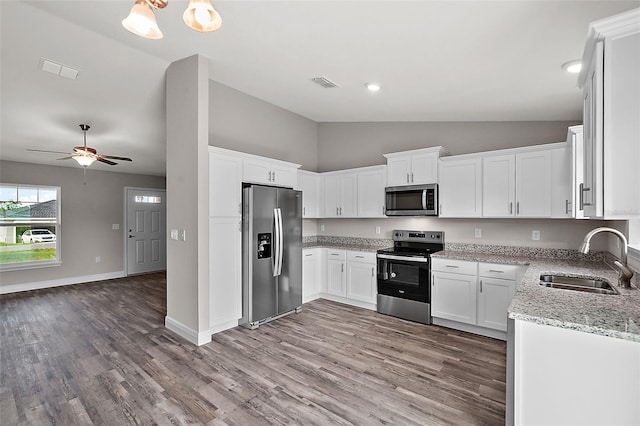 kitchen with white cabinetry, sink, ceiling fan, stainless steel appliances, and light stone counters