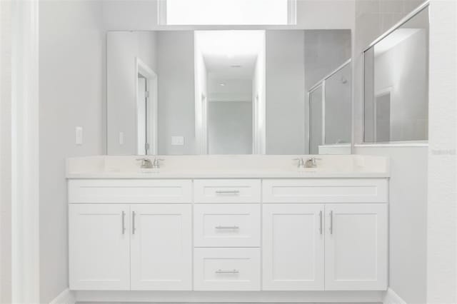 bathroom featuring vanity and an enclosed shower