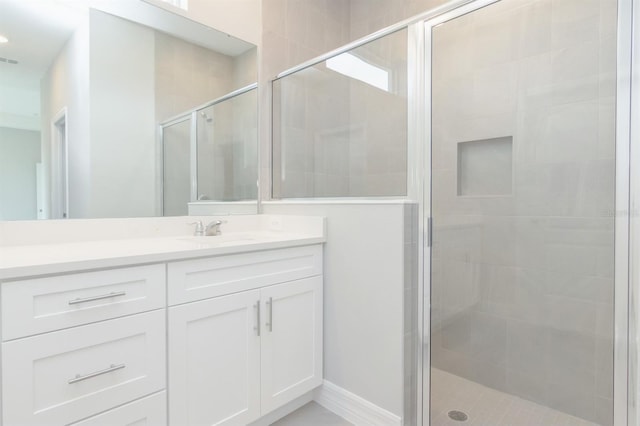 bathroom with vanity and a shower with shower door