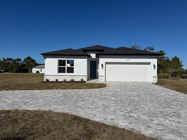 view of front of property with a front yard and a garage