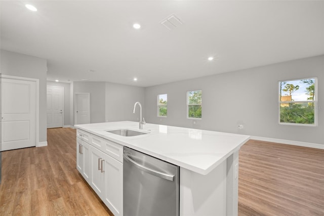 kitchen featuring stainless steel dishwasher, light hardwood / wood-style flooring, a kitchen island with sink, white cabinets, and sink