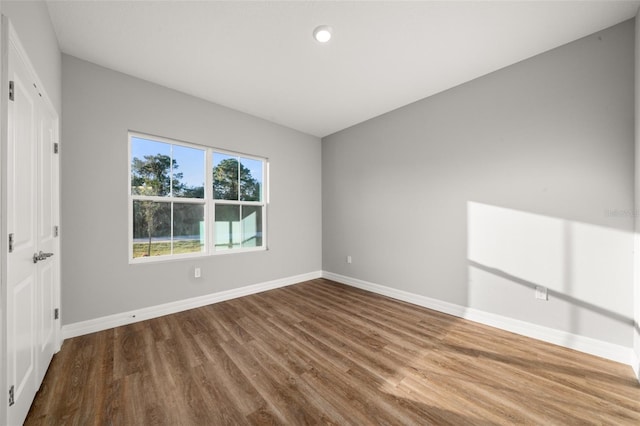 spare room with hardwood / wood-style floors