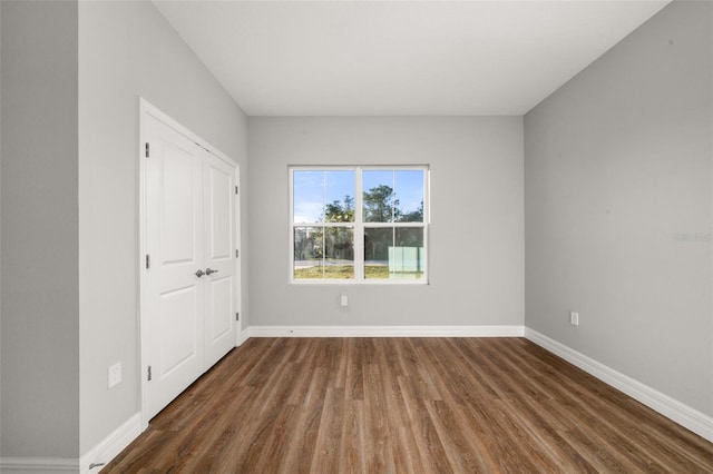 empty room featuring dark wood-type flooring