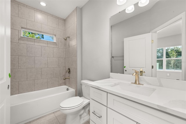 full bathroom featuring vanity, tile patterned floors, tiled shower / bath combo, and toilet