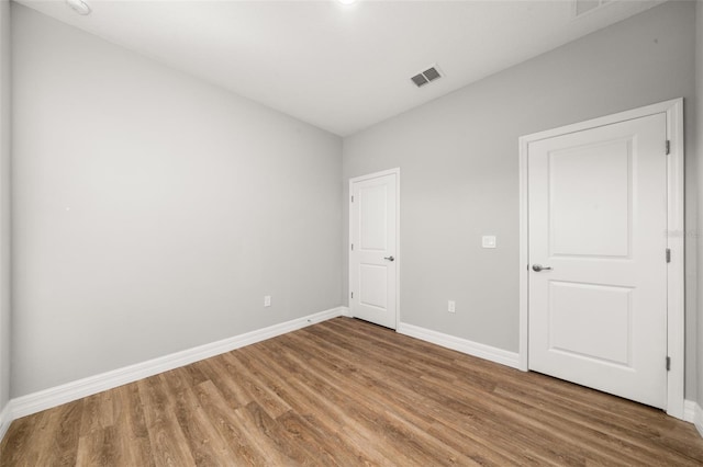 unfurnished bedroom with hardwood / wood-style floors